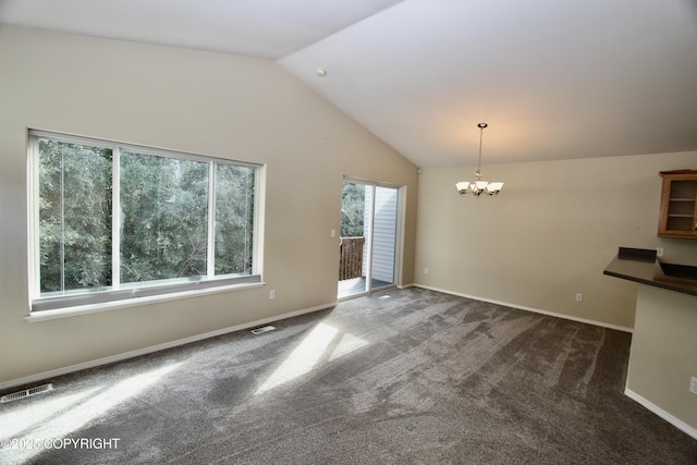 11613 Birch Knoll Loop, Anchorage, AK 99515 - unfurnished living room featuring lofted ceiling, a chandelier, and dark colored carpet