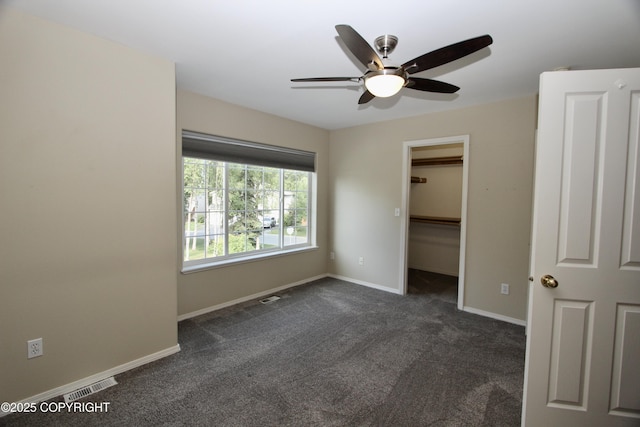 11613 Birch Knoll Loop, Anchorage, AK 99515 - unfurnished bedroom featuring dark carpet, a spacious closet, and ceiling fan