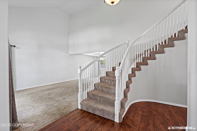 3561 Eastwind Dr, Anchorage, AK 99516 - stairs featuring wood finished floors and high vaulted ceiling