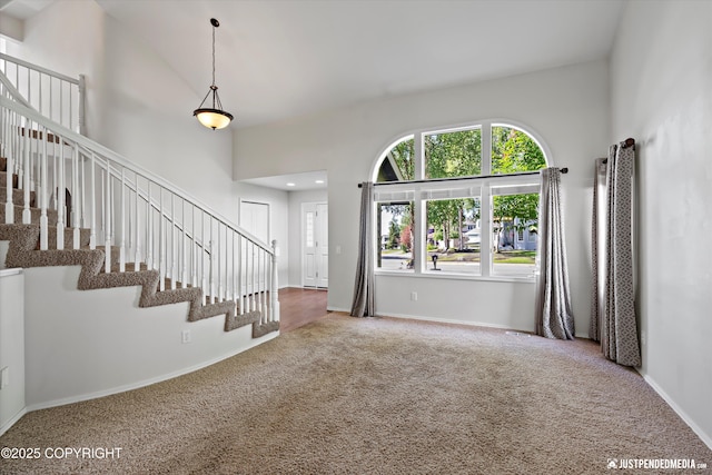 3561 Eastwind Dr, Anchorage, AK 99516 - foyer featuring carpet flooring, a towering ceiling, and stairs