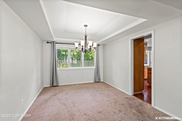 3561 Eastwind Dr, Anchorage, AK 99516 - carpeted spare room with a tray ceiling and a chandelier