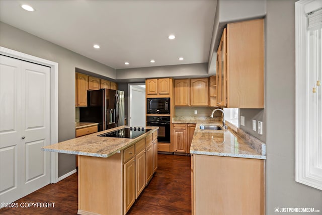 3561 Eastwind Dr, Anchorage, AK 99516 - kitchen with black appliances, a kitchen island, light stone counters, dark wood finished floors, and recessed lighting