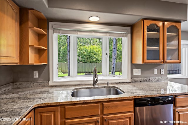 3561 Eastwind Dr, Anchorage, AK 99516 - kitchen featuring dishwasher, glass insert cabinets, plenty of natural light, and light stone countertops