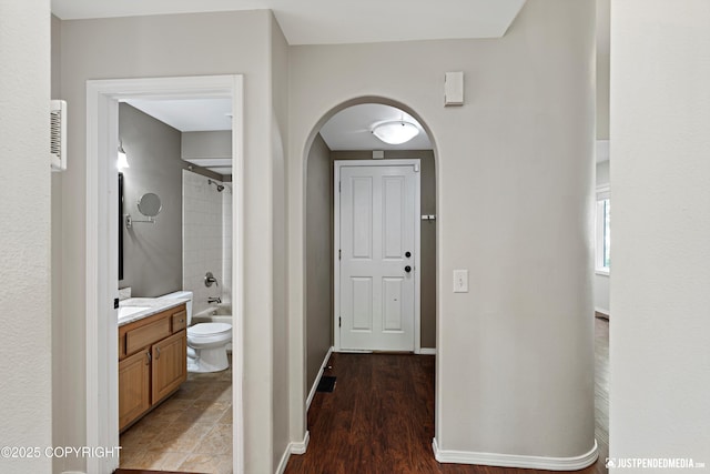 3561 Eastwind Dr, Anchorage, AK 99516 - foyer entrance with arched walkways and light wood-style floors