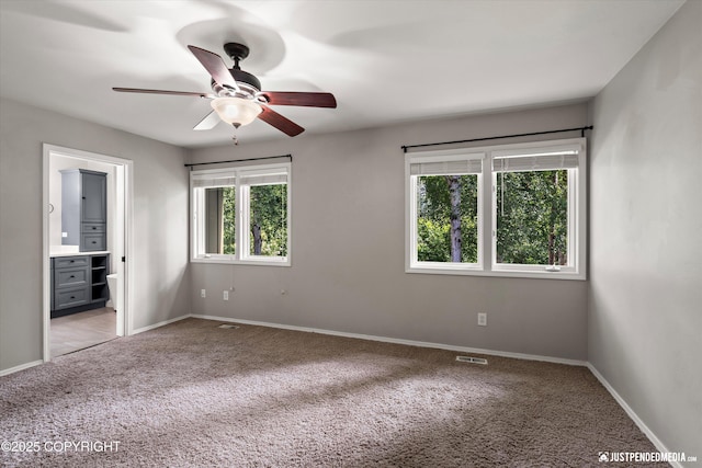 3561 Eastwind Dr, Anchorage, AK 99516 - unfurnished bedroom featuring carpet, connected bathroom, and a ceiling fan