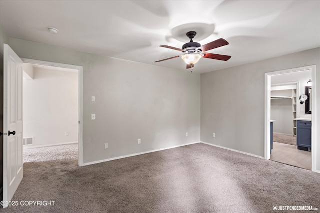 3561 Eastwind Dr, Anchorage, AK 99516 - unfurnished bedroom with carpet flooring, a spacious closet, and ceiling fan