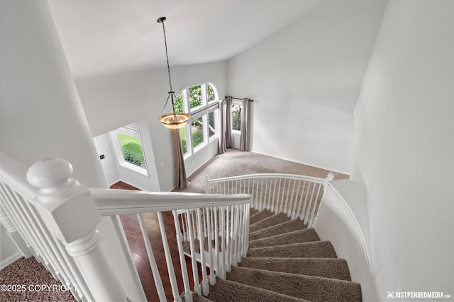 3561 Eastwind Dr, Anchorage, AK 99516 - staircase featuring carpet and high vaulted ceiling