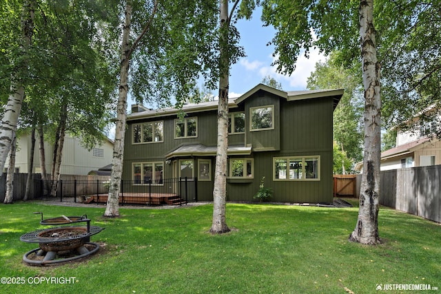3561 Eastwind Dr, Anchorage, AK 99516 - rear view of property featuring an outdoor fire pit and a fenced backyard