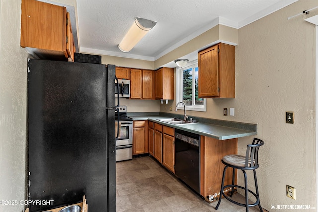 8051 Evans Cir, Anchorage, AK 99507 - kitchen with black appliances, brown cabinetry, dark countertops, and a textured wall