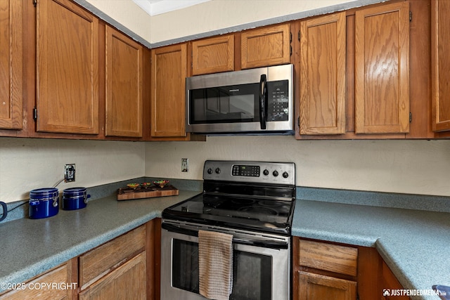 8051 Evans Cir, Anchorage, AK 99507 - kitchen with appliances with stainless steel finishes, brown cabinets, and dark countertops
