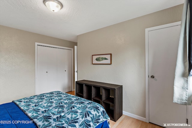 8051 Evans Cir, Anchorage, AK 99507 - bedroom with light wood-type flooring and a textured wall