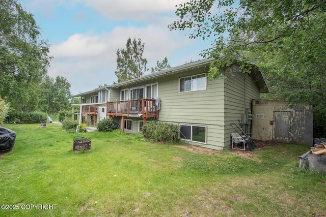 4111 Grape Pl, Anchorage, AK 99508 - rear view of property featuring an outdoor fire pit, a lawn, and a wooden deck