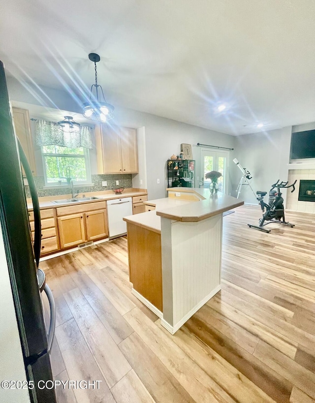 2711 N Woodfield Dr, Wasilla, AK 99654 - kitchen featuring dishwasher, light wood finished floors, light countertops, and plenty of natural light