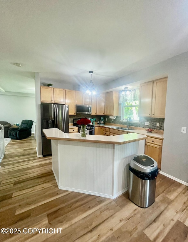 2711 N Woodfield Dr, Wasilla, AK 99654 - kitchen with appliances with stainless steel finishes, light wood-type flooring, light countertops, light brown cabinets, and tasteful backsplash