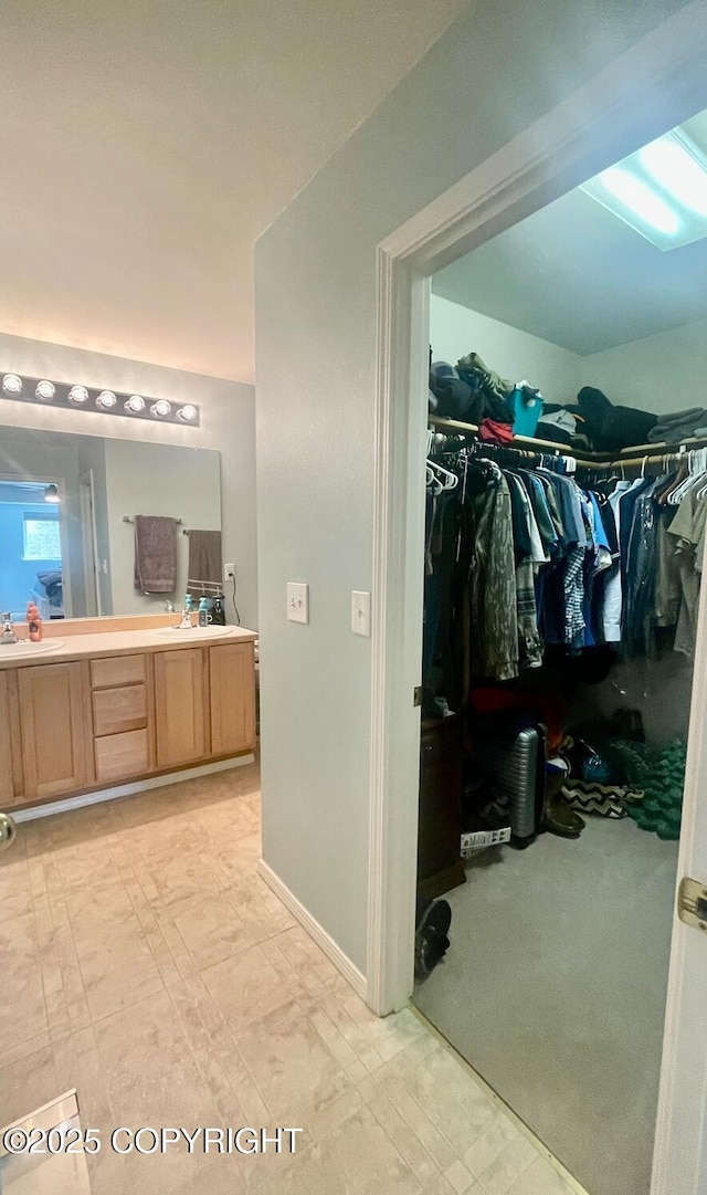 2711 N Woodfield Dr, Wasilla, AK 99654 - bathroom featuring double vanity and a walk in closet