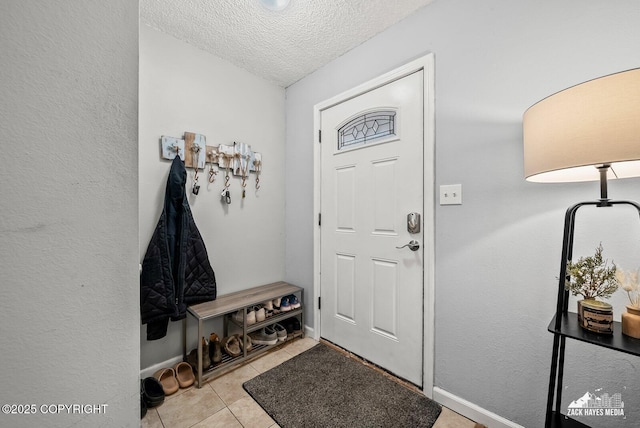 7200 Kiska Cir, Anchorage, AK 99504 - entryway featuring a textured ceiling and light tile patterned floors