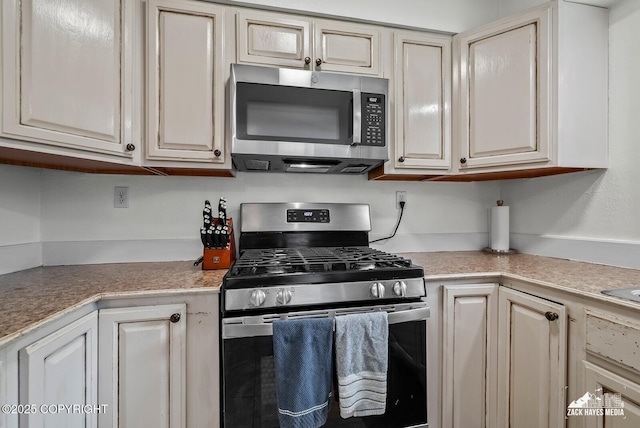 7200 Kiska Cir, Anchorage, AK 99504 - kitchen with stainless steel appliances, light countertops, and cream cabinets