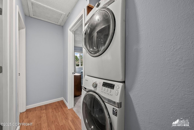 7200 Kiska Cir, Anchorage, AK 99504 - laundry area featuring stacked washer / dryer, attic access, and light wood-style flooring