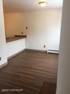 1911 Marthas Vineyard Cir, Anchorage, AK 99507 - unfurnished dining area featuring wood finished floors and a baseboard heating unit