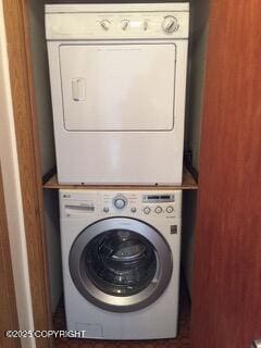 1911 Marthas Vineyard Cir, Anchorage, AK 99507 - laundry room featuring stacked washer and clothes dryer