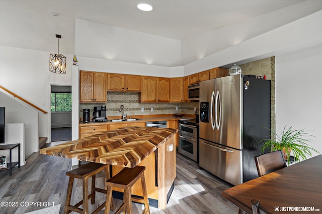 1544 State St, Anchorage, AK 99504 - kitchen featuring stainless steel appliances, dark wood-type flooring, butcher block countertops, tasteful backsplash, and pendant lighting