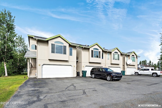 1544 State St, Anchorage, AK 99504 - view of front facade featuring an attached garage, driveway, and stairs