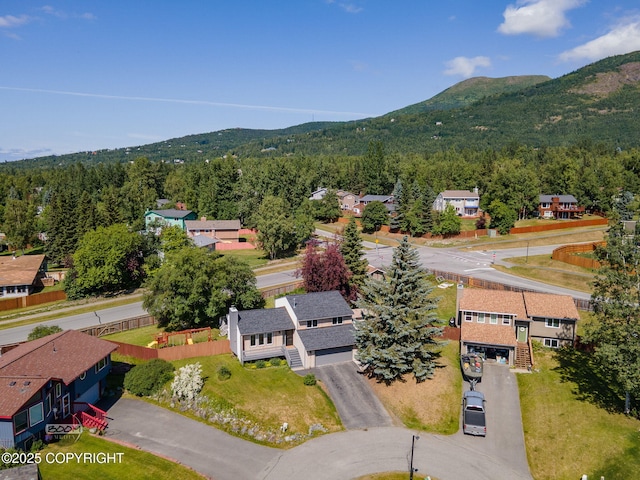 9645 Nulato Cir, Eagle River, AK 99577 - aerial view of residential area featuring a heavily wooded area and a mountain backdrop