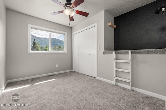 9645 Nulato Cir, Eagle River, AK 99577 - unfurnished bedroom with carpet flooring, a closet, and ceiling fan