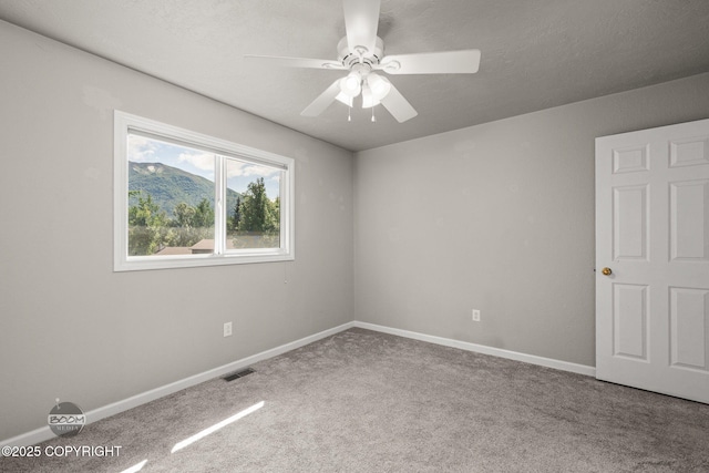 9645 Nulato Cir, Eagle River, AK 99577 - spare room featuring carpet and a ceiling fan