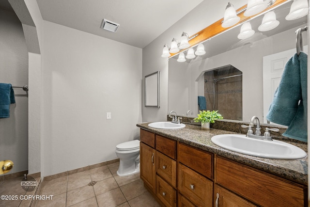 9645 Nulato Cir, Eagle River, AK 99577 - bathroom with tiled shower, double vanity, and tile patterned floors