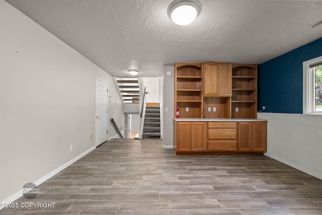 9645 Nulato Cir, Eagle River, AK 99577 - unfurnished office with a textured ceiling, light wood-style flooring, and wainscoting