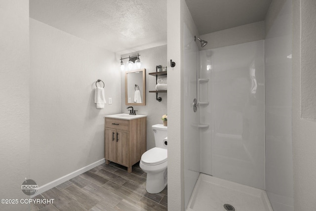 9645 Nulato Cir, Eagle River, AK 99577 - full bathroom featuring vanity, wood finished floors, a shower, and a textured ceiling