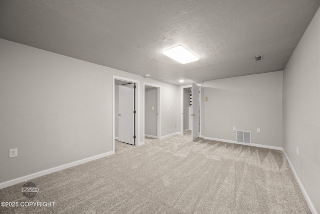 9645 Nulato Cir, Eagle River, AK 99577 - finished basement featuring a textured ceiling and light carpet