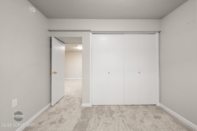 9645 Nulato Cir, Eagle River, AK 99577 - unfurnished bedroom with carpet flooring, a closet, and a textured ceiling