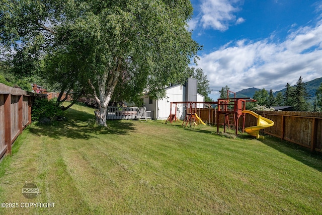 9645 Nulato Cir, Eagle River, AK 99577 - fenced backyard featuring a playground