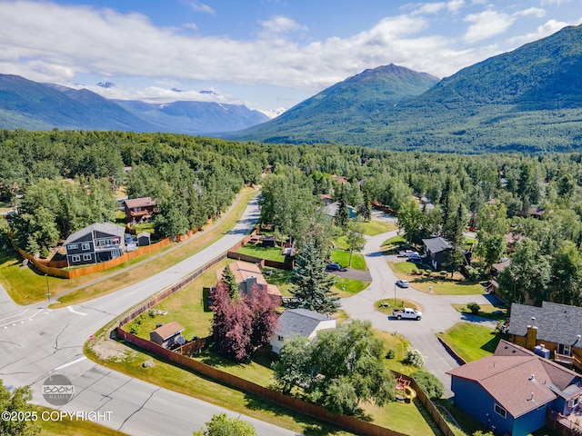 9645 Nulato Cir, Eagle River, AK 99577 - aerial view of a heavily wooded area and a mountain backdrop