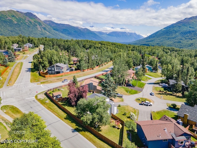 9645 Nulato Cir, Eagle River, AK 99577 - aerial perspective of suburban area with a heavily wooded area and a mountain backdrop