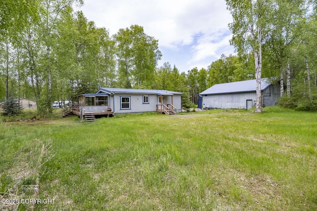 1801 W That Rd, Wasilla, AK 99623 - back of house with an outdoor structure and a wooden deck