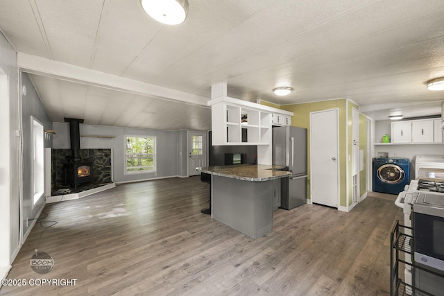 1801 W That Rd, Wasilla, AK 99623 - kitchen featuring washer / dryer, freestanding refrigerator, open shelves, and open floor plan