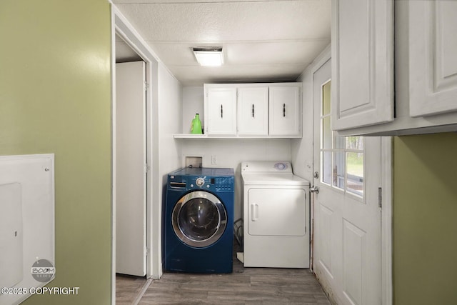 1801 W That Rd, Wasilla, AK 99623 - laundry room featuring washing machine and dryer, cabinet space, wood finished floors, and a textured ceiling
