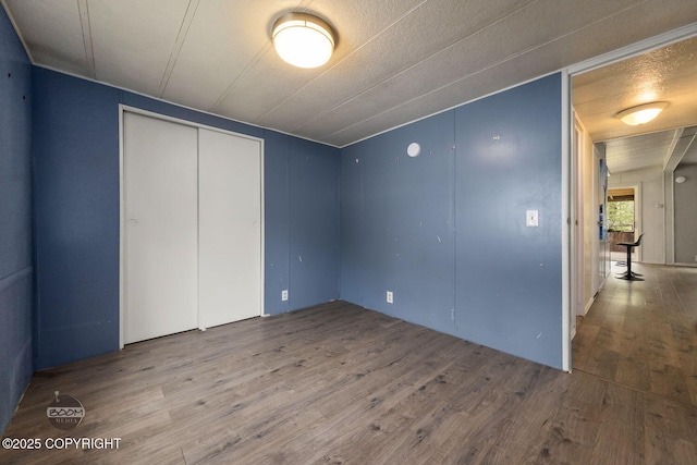 1801 W That Rd, Wasilla, AK 99623 - unfurnished bedroom with wood finished floors and a closet