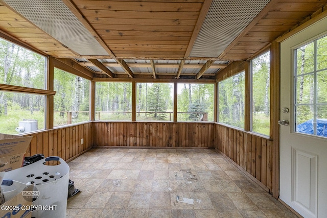 1801 W That Rd, Wasilla, AK 99623 - unfurnished sunroom featuring stone finish flooring, wood walls, and healthy amount of natural light