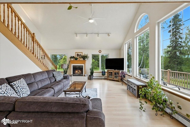 48350 Lakeside Ave, Soldotna, AK 99669 - living area with healthy amount of natural light, wood finished floors, a ceiling fan, and a tiled fireplace