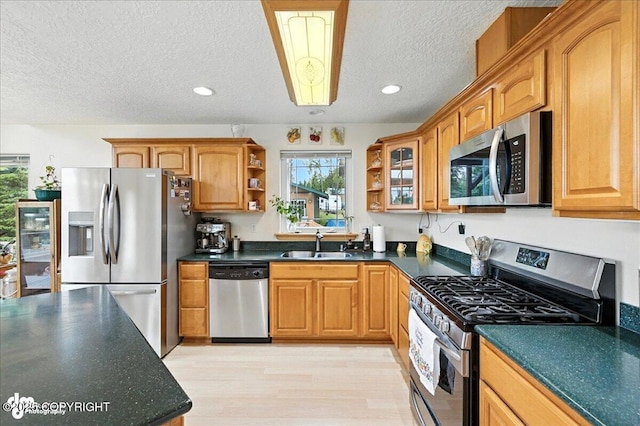 48350 Lakeside Ave, Soldotna, AK 99669 - kitchen featuring appliances with stainless steel finishes, dark countertops, open shelves, a textured ceiling, and brown cabinets