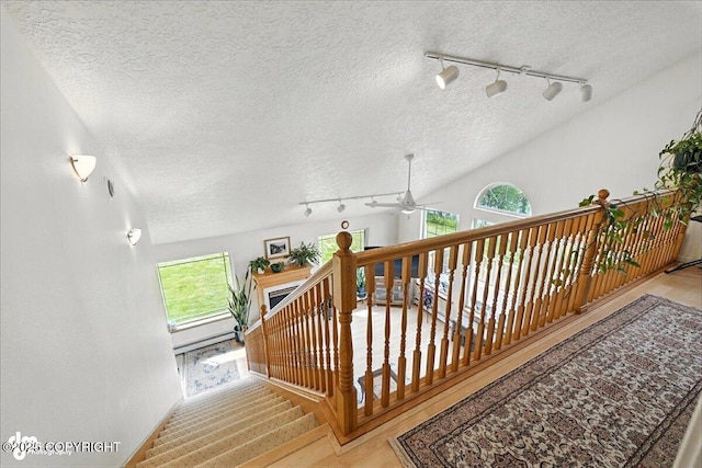 48350 Lakeside Ave, Soldotna, AK 99669 - staircase featuring rail lighting, a textured ceiling, and a ceiling fan