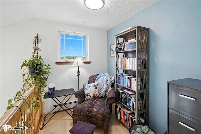 48350 Lakeside Ave, Soldotna, AK 99669 - sitting room with wood finished floors, a textured ceiling, and a baseboard radiator
