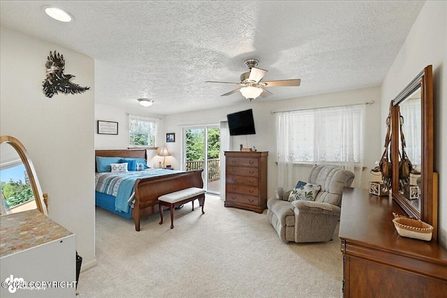 48350 Lakeside Ave, Soldotna, AK 99669 - bedroom featuring light colored carpet, access to exterior, a textured ceiling, and ceiling fan