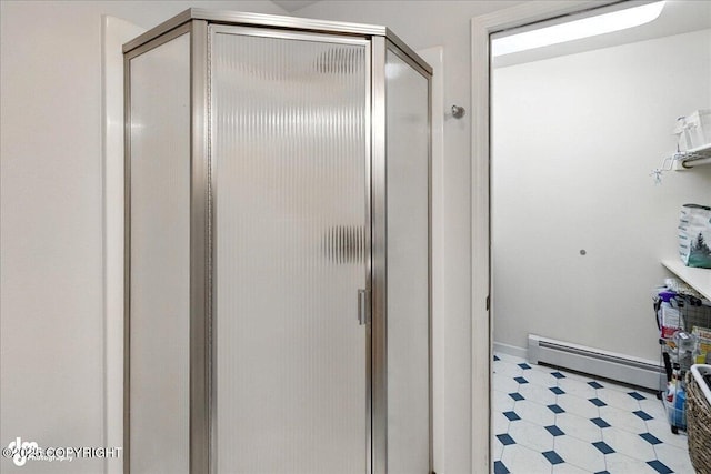 48350 Lakeside Ave, Soldotna, AK 99669 - full bathroom featuring a baseboard radiator, tile patterned floors, and a stall shower