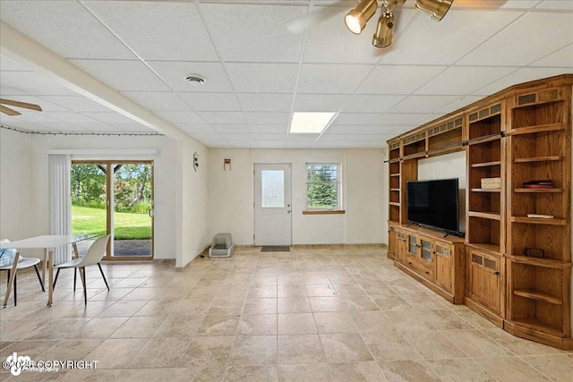 48350 Lakeside Ave, Soldotna, AK 99669 - unfurnished living room with a ceiling fan, a drop ceiling, and healthy amount of natural light