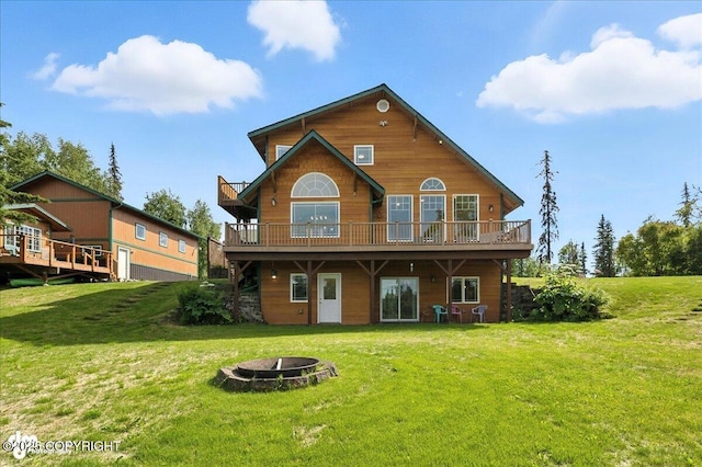 48350 Lakeside Ave, Soldotna, AK 99669 - back of property featuring an outdoor fire pit, a deck, and a yard
